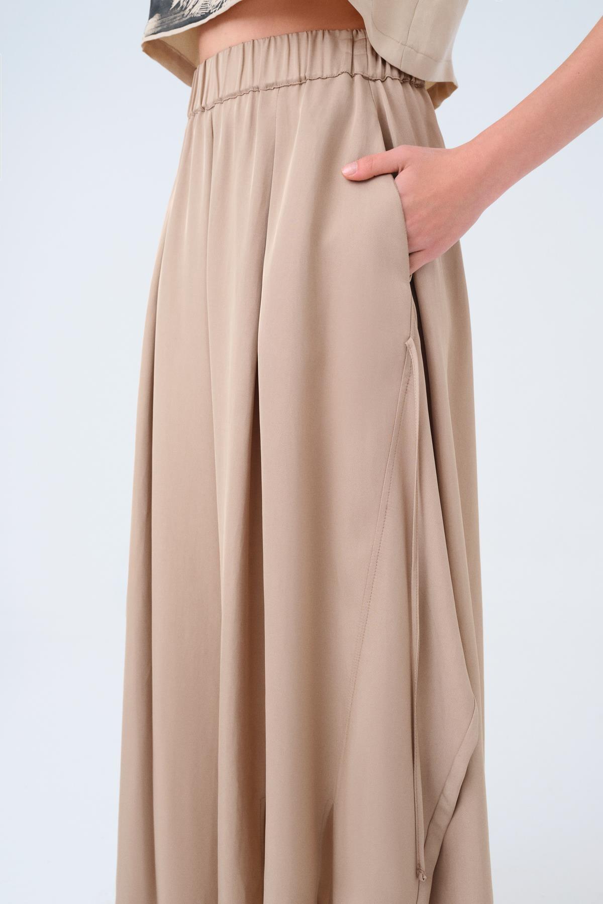 BEJ PİLELİ ASİMETRİK KESİM BOL PAÇA PANTOLON - MİİN